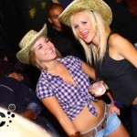 two women wearing cowboy hats